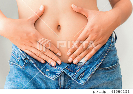 Young woman showing successful weight loss Young woman showing successful weight loss 41666131