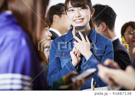 女性 行き交う人々 スマートフォン 女性 行き交う人々 スマートフォン 41667136