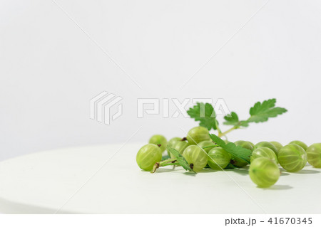 Green gooseberry on a round wooden table. Green gooseberry on a round wooden table. 41670345