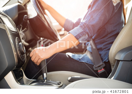 woman driver hand shifting the gear stick 41672801