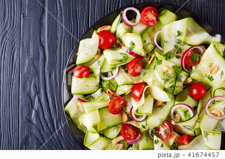 zucchini ribbon salad on a black plate 41674457