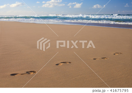 Footprints in the sand on ocean beach. Footprints in the sand on ocean beach. 41675795
