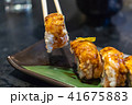 chopsticks holding salmon sushi roll 41675883
