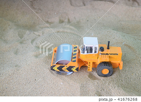 Car toy road roller construction sand background 41676268