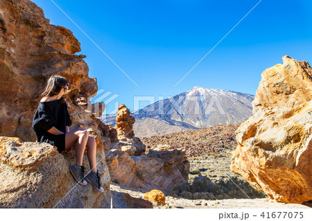 Young traveler woman enjoy view of Teide volcano Young traveler woman enjoy view of Teide volcano 41677075