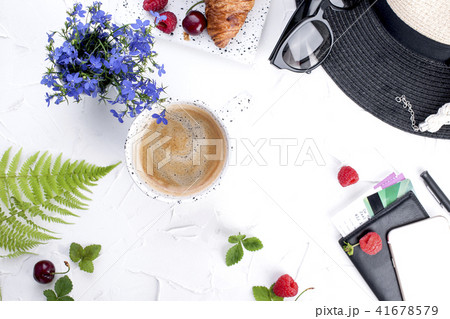 Women's accessories, lady on vacation. Sunglasses and hat, croissant and coffee for breakfast. Women's accessories, lady on vacation. Sunglasses and hat, croissant and coffee for breakfast. 41678579