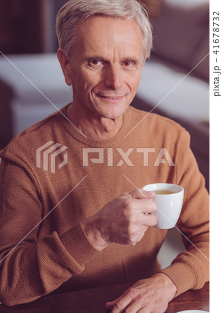 Pleased pensioner raising right arm Pleased pensioner raising right arm 41678732