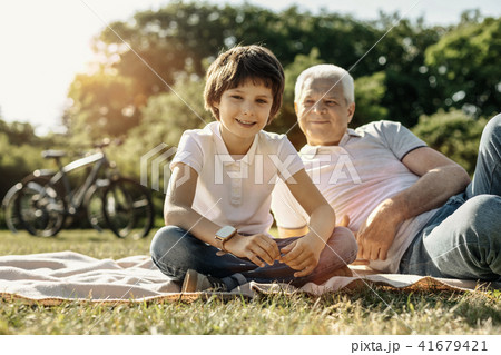 Smiling boy relaxing with his grandpa 41679421