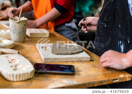 Pottery workshop. hands make print on clay Pottery workshop. hands make print on clay 41679820