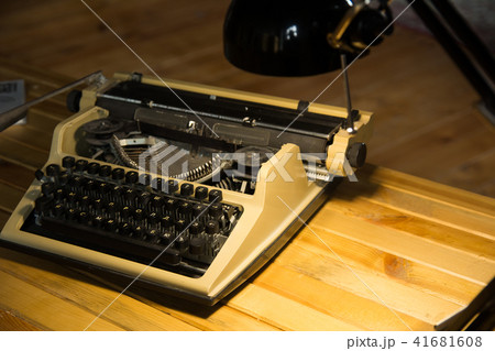 An old typewriter illuminated by a lamp  41681608
