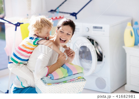 Family in laundry room with washing machine Family in laundry room with washing machine 41682981