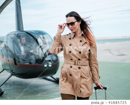 Business woman near private helicopter 41685725