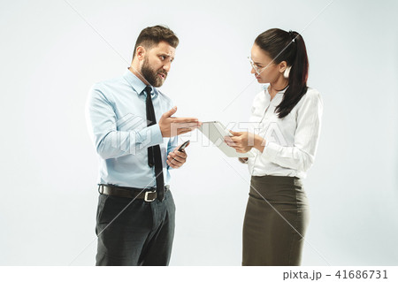 a business man shows the laptop to his colleague in the office. 41686731