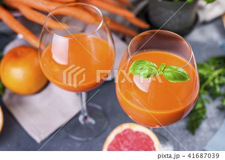Juice from fresh carrots and basil in a glass, vitamin drink for a healthy diet. Copy space Juice from fresh carrots and basil in a glass, vitamin drink for a healthy diet. Copy space 41687039