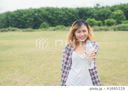 young hipster woman holding bottle of water young hipster woman holding bottle of water 41695229