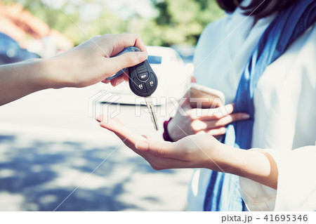 Woman's hand give the car key. Woman's hand give the car key. 41695346