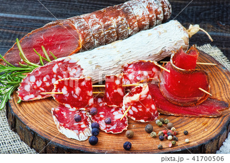 Sliced cured sausage, meat  with spices. 41700506