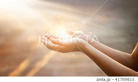 Woman hands praying on sunset background Woman hands praying on sunset background 41700615