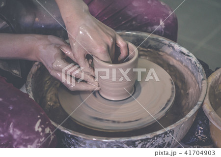 Creating ceramic products of white clay close-up. Creating ceramic products of white clay close-up. 41704903