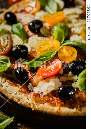 Traditional italian pizza on wooden table Traditional italian pizza on wooden table 41706394