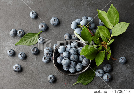 Fresh blueberries branch on black stone background Fresh blueberries branch on black stone background 41706418