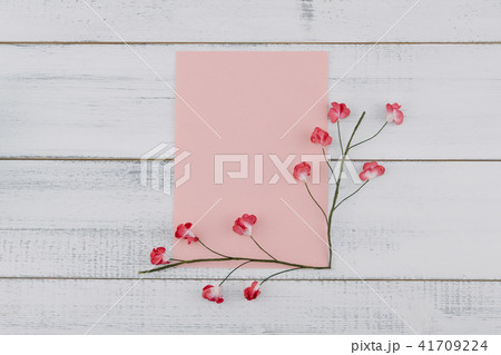 Blank pink card decorate with red paper flowers 41709224