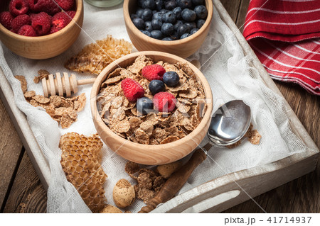Bowl of cereals with blueberries and raspberrie. Bowl of cereals with blueberries and raspberrie. 41714937