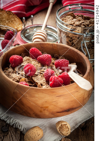 Bowl of cereals with blueberries and raspberrie. Bowl of cereals with blueberries and raspberrie. 41714942