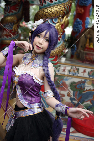 Portrait of asian young woman dancing with purple Chinese dress cosplay with temple Portrait of asian young woman dancing with purple Chinese dress cosplay with temple 41724039