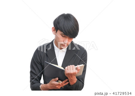 student reading book for exam on white background. 41729534