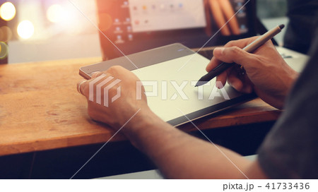 Designer with wireless digital drawing pen mouse. 41733436