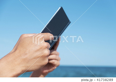 man reading a book on the beach man reading a book on the beach 41738289
