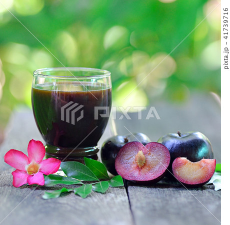 fresh plums juice on a wooden background fresh plums juice on a wooden background 41739716