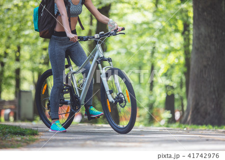 Sporty woman is cycling in park 41742976