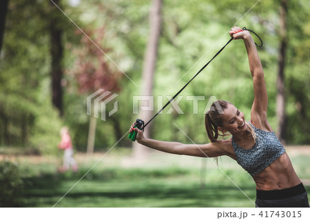 Slim lady is laughing while stretching 41743015