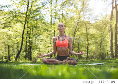 Carefree woman is meditating in nature 41743109