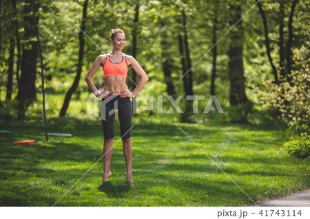 Cheerful lady is tiptoeing on grass Cheerful lady is tiptoeing on grass 41743114