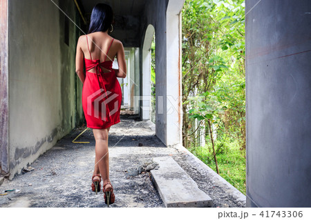 Asian girl in red dress walking in old building Asian girl in red dress walking in old building 41743306