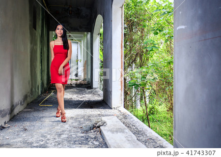 Asian girl in red dress walking in old building Asian girl in red dress walking in old building 41743307