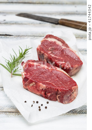 Dry aged rib-eye steak raw on paper  41744342