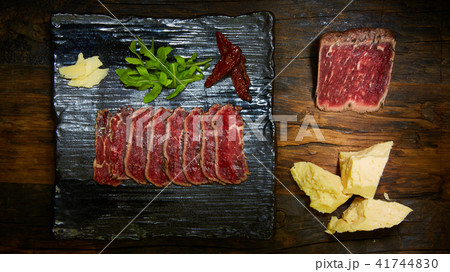 Barbecue wagyu roast beef sliced as top view on a metal tray with copy space right 41744830