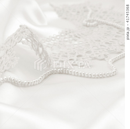 Smooth elegant golden silk or satin with pearls  41745368