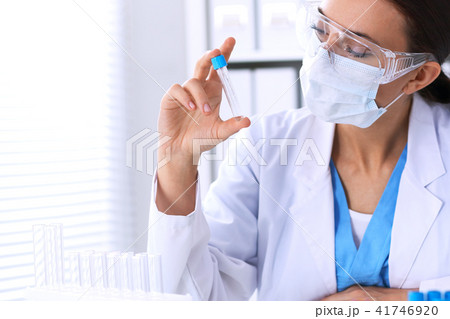 Female scientific research is looking at the tube in laboratory. Blood test concept 41746920