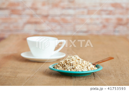 Oats flakes in dish on wood table Oats flakes in dish on wood table 41753593