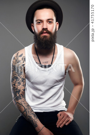Brutal hipster boy with tattoo Brutal hipster boy with tattoo 41755170