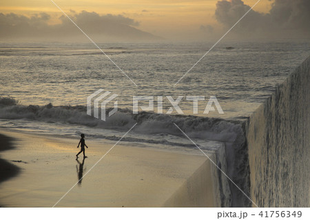 Silhouette of a boy on the beach at sunset. Silhouette of a boy on the beach at sunset. 41756349