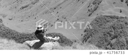 Young girl photographer shoots at the camera Young girl photographer shoots at the camera 41756733