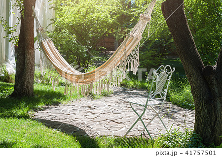 Summer garden with hanging hammock for relax Summer garden with hanging hammock for relax 41757501