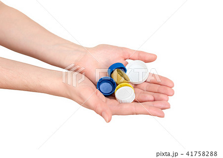 Female hand holding plastic bottle caps. Two hands 41758288