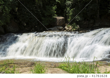 Waterfalls, sky and green trees. 41761628